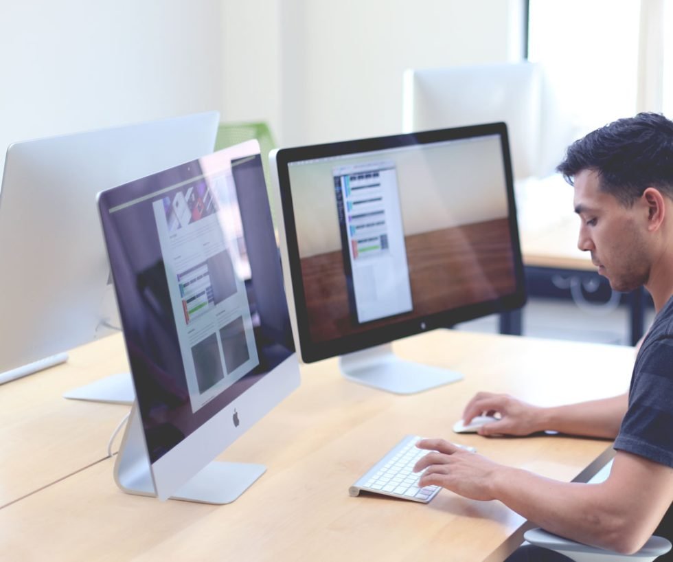 Designer working on a website at a desktop computer